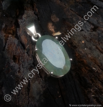 Aquamarine natural crystal pendant on tree log